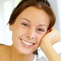A young woman smiles after learning to manage her dental phobia